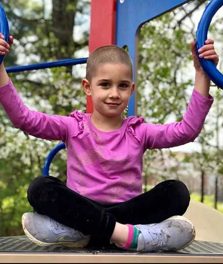 Child sitting on playground equipment